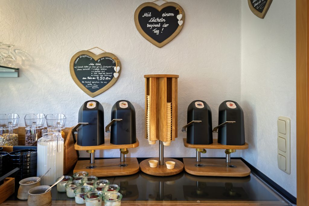 Frühstücksbuffet mit Frühstückszutaten und Automaten.